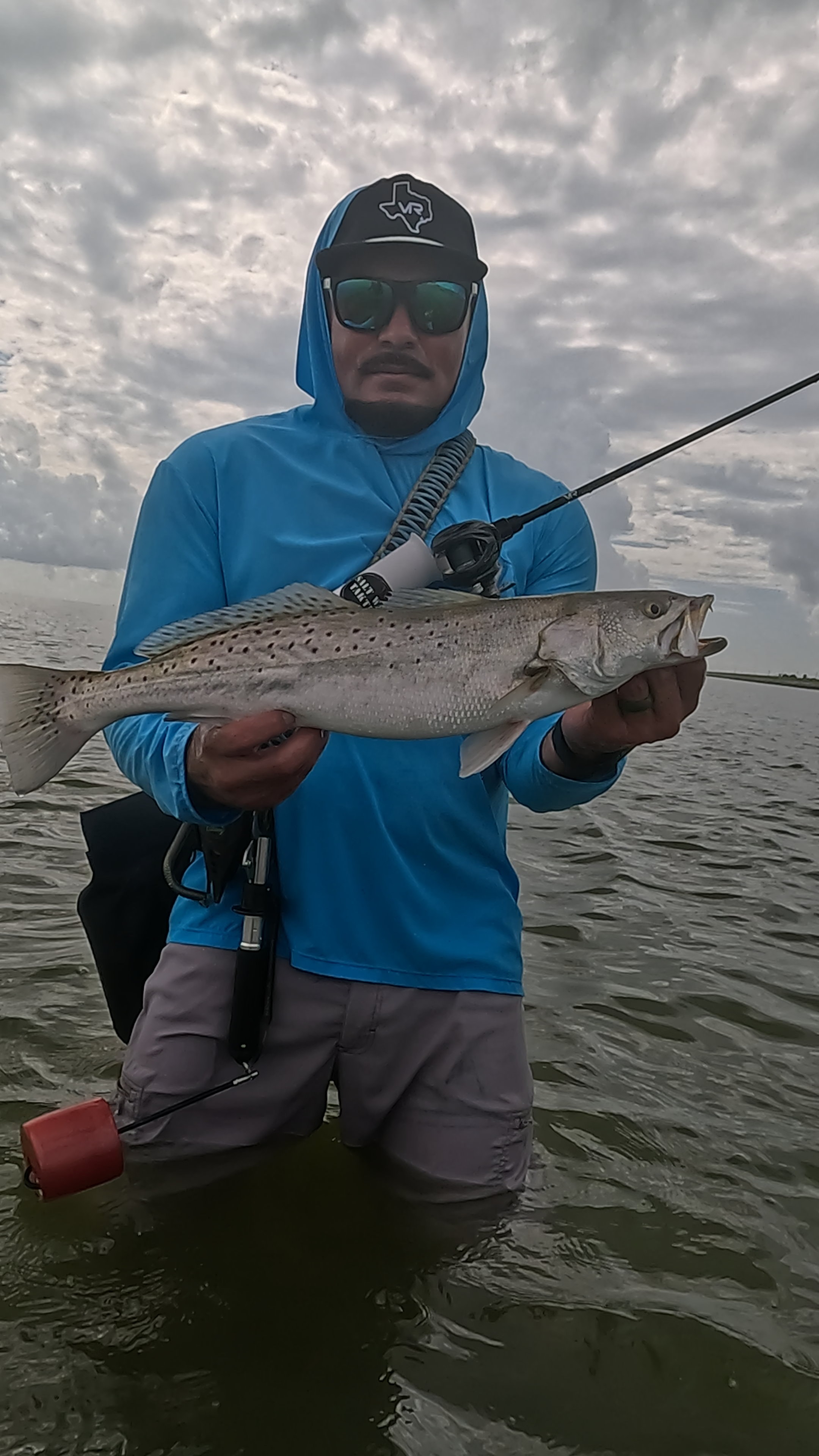 Fisherman holding a caught trout in the water
